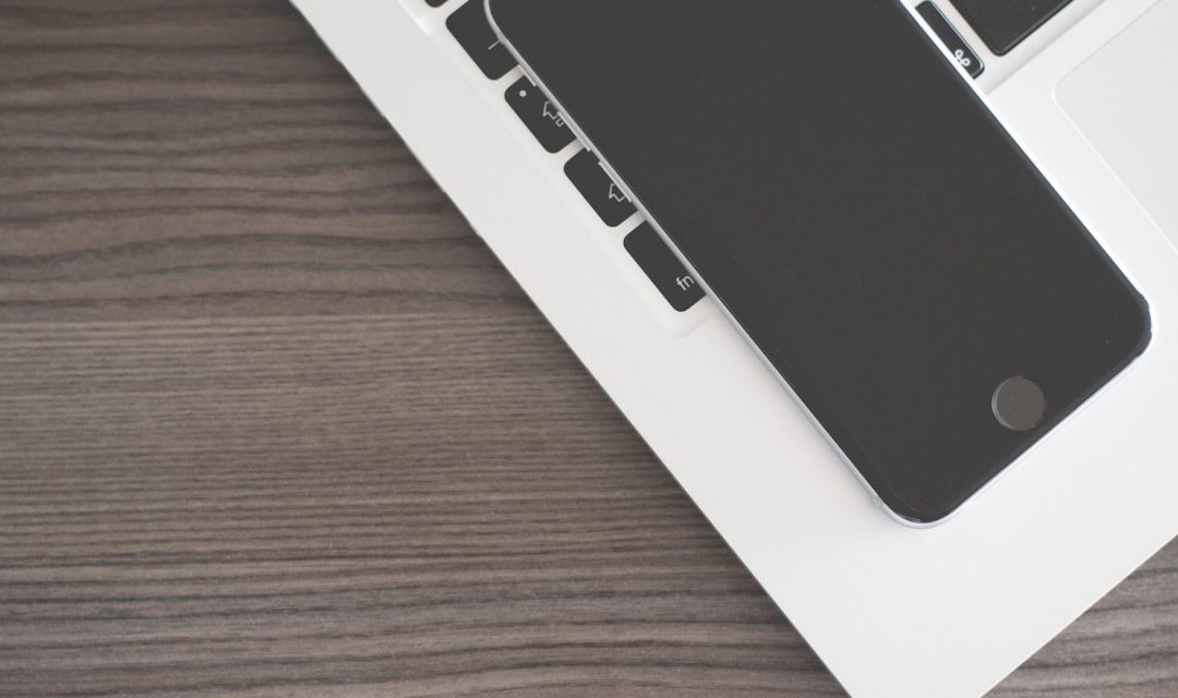 mobile on top of a laptop