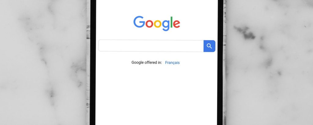 mobile phone showing Google search bar