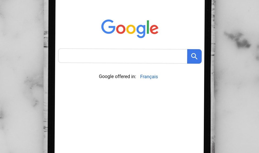mobile phone showing Google search bar